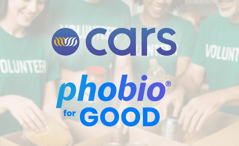CARS and Phobio for Good logos over a faded photo of volunteers in green "Volunteer" T-shirts packing donation boxes.